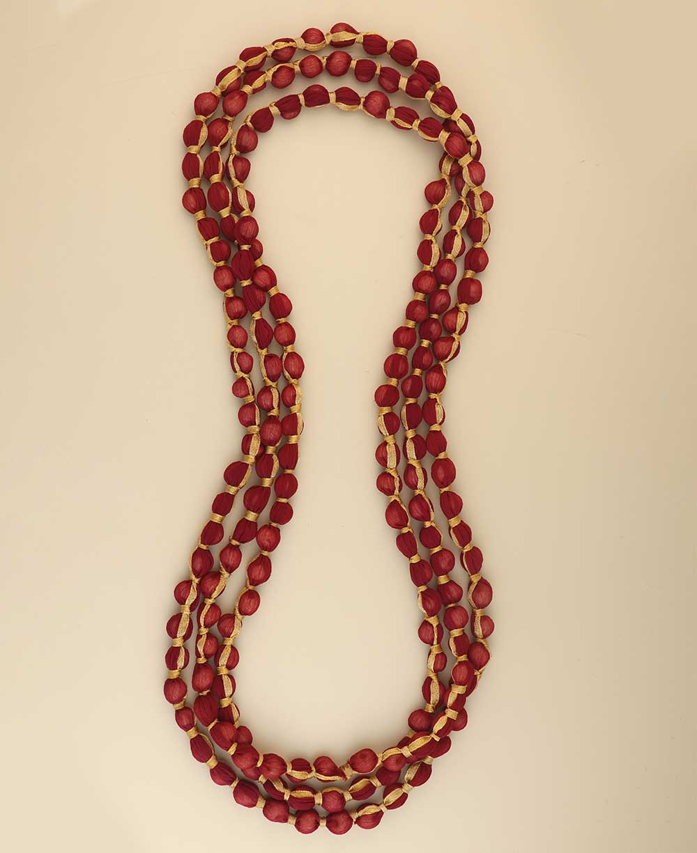 Long red and beige fabric bead necklace