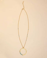 Gold-plated circle pendant necklace with turquoise accents