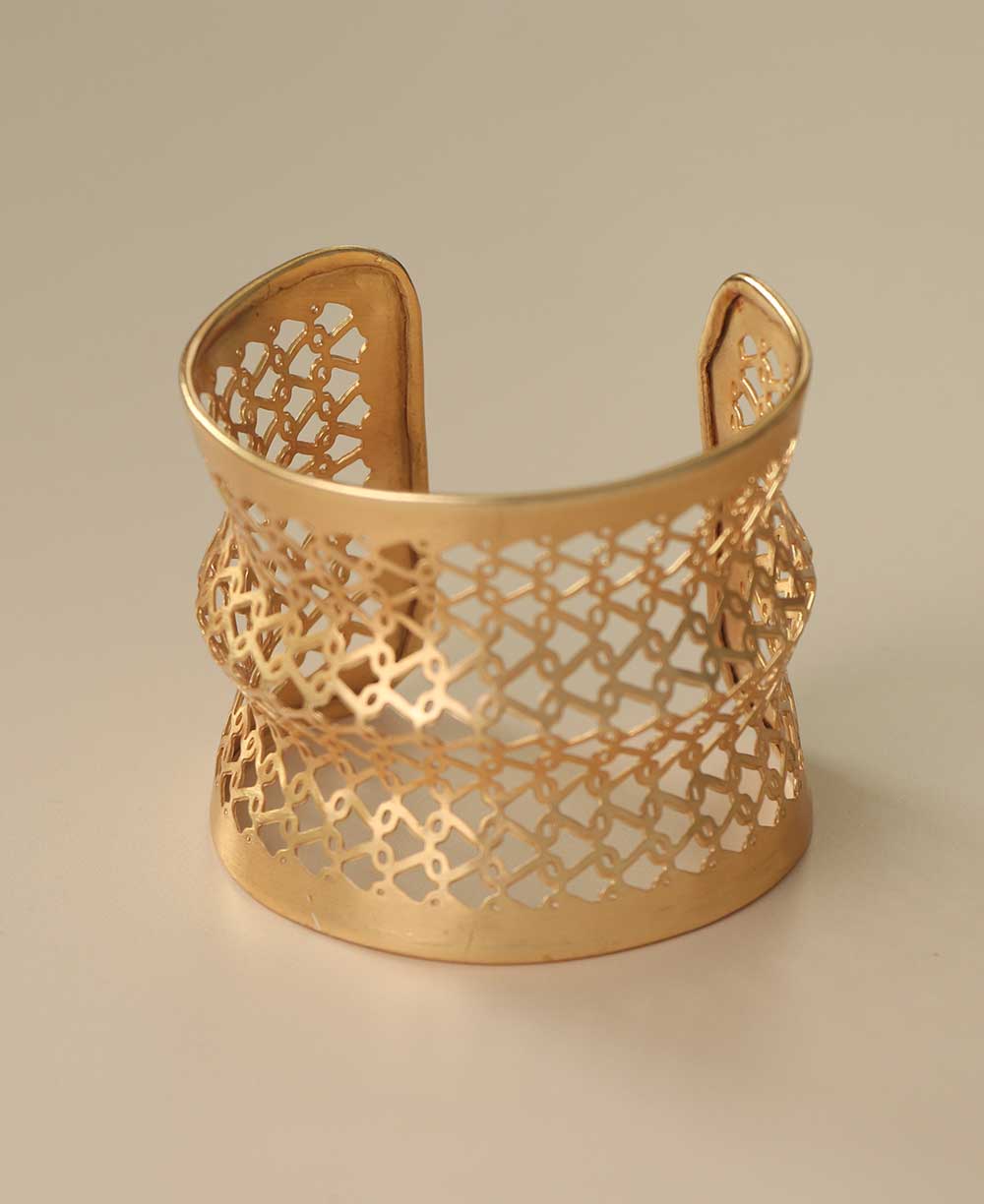 Handcrafted gold-tone lattice cuff bracelet.