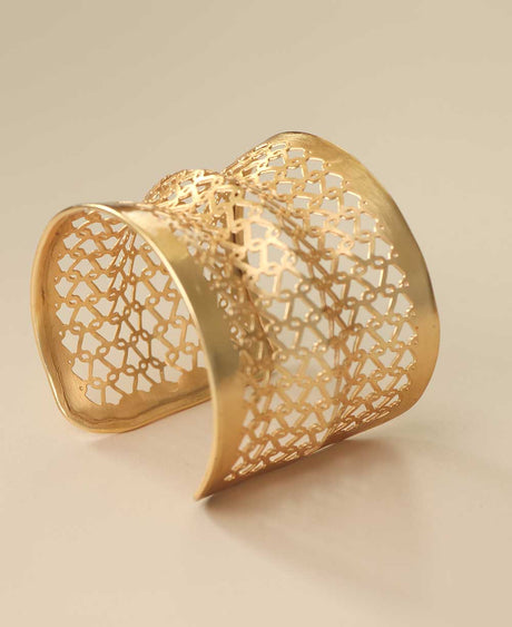 Adjustable gold-tone wide cuff bracelet with openwork pattern.