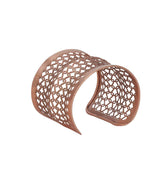 Sculptural silver-plated cuff bracelet with circular design.