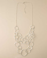 Silver-plated multi-layered hammered ring necklace.