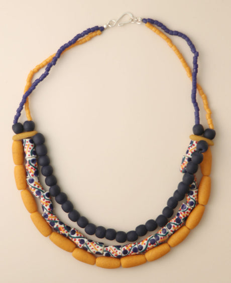 Asymmetric recycled glass bead necklace with navy, mustard, and white colors