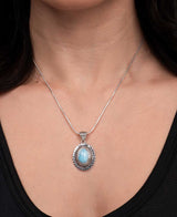 Oval larimar pendant with intricate silver frame