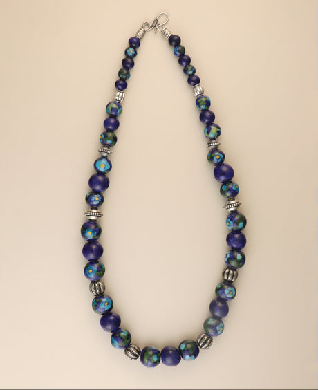 Hand-painted blue pottery bead necklace with floral accents.