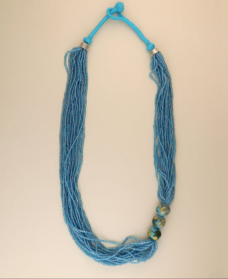 Multi-strand aqua blue glass bead necklace with ceramic accents.