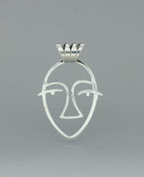 Close-up image of the sterling silver Picasso Face cut-out pendant