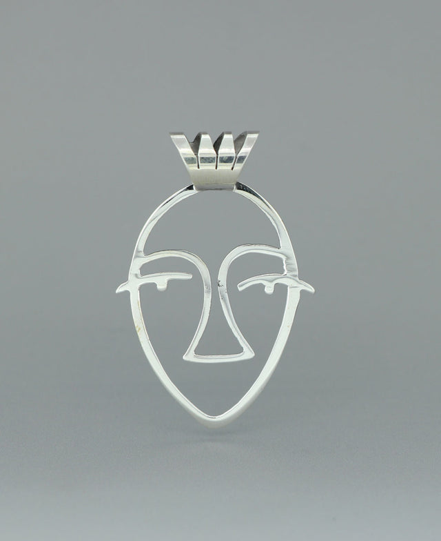 Close-up image of the sterling silver Picasso Face cut-out pendant