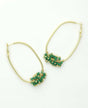 Gold-plated brass hoop earrings with green glass beads.