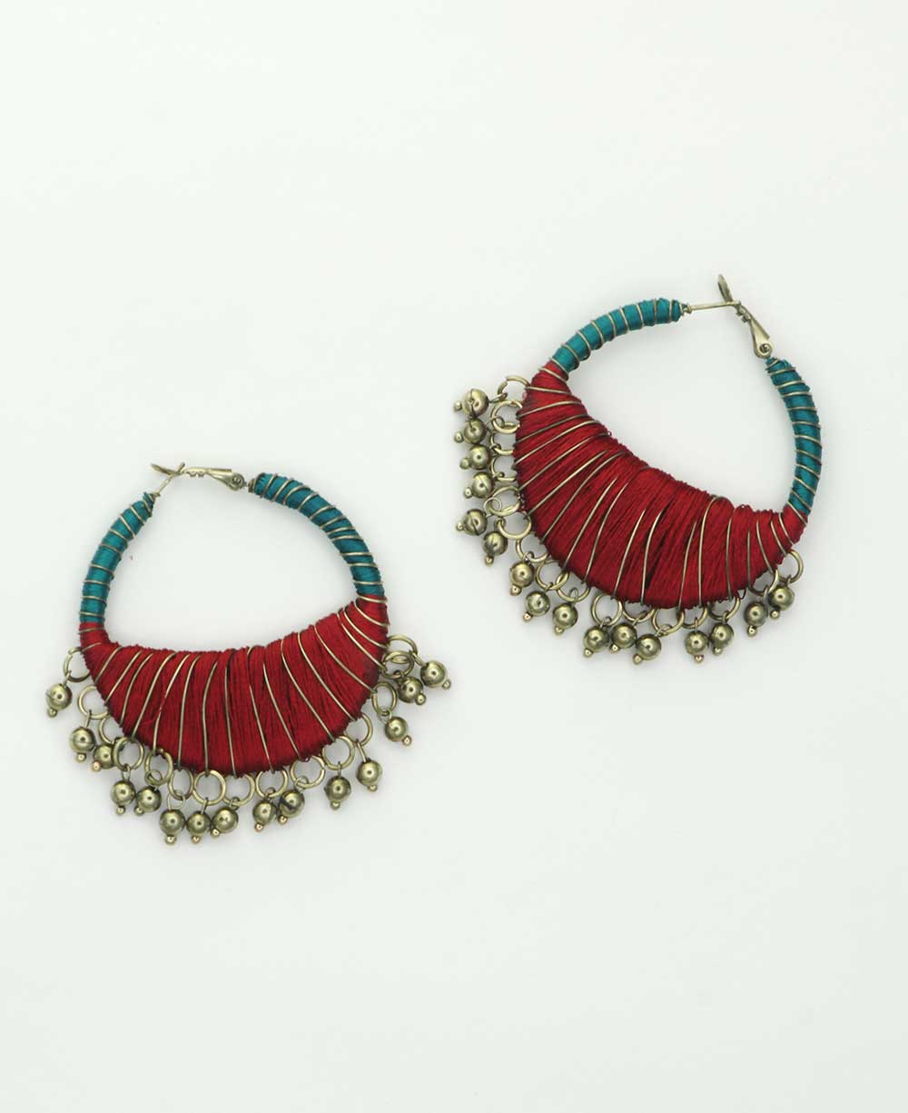 Teal and maroon thread-wrapped hoop earrings with metal accents.