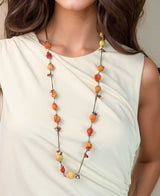 Long necklace with glass beads and textile accents.