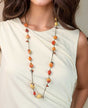 Long necklace with glass beads and textile accents.