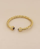 Elegant gold plated brass bracelet, showcasing its adjustable open-ended design and unique twisted rope pattern