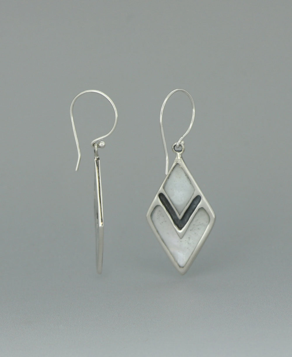 Sterling silver Mother of Pearl earrings, highlighting the elongated diamond shape and the contrast between the lustrous shell and sleek silver frame