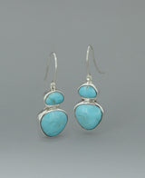 Full view of the sterling silver Genuine Turquoise dangling earrings against a light background, emphasizing the vibrant Kingman turquoise