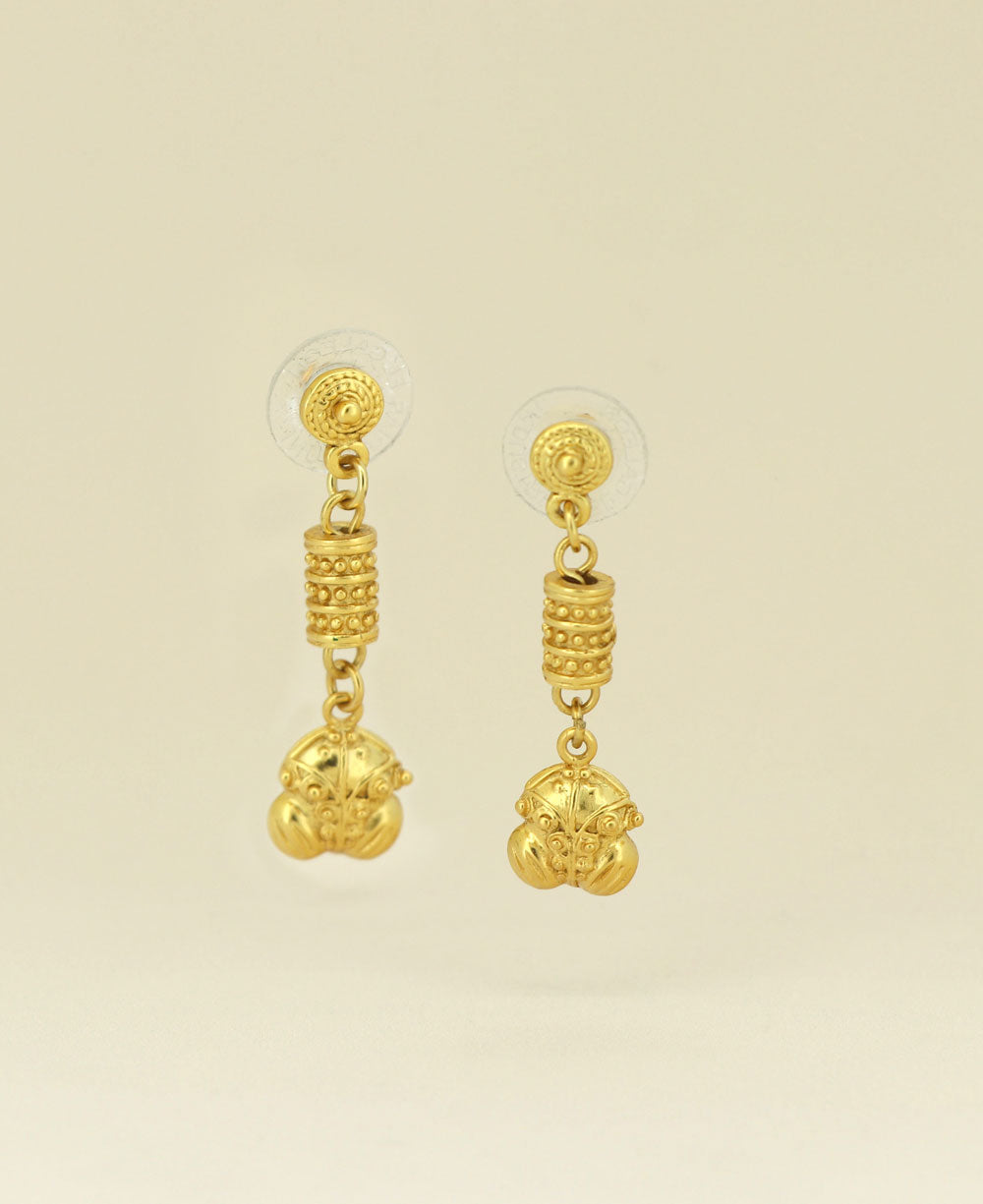 Close-up of the Gold Plated Colombian Frog Symbol Earrings showing the intricate frog carving and radiant gold plating