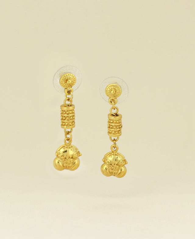 Close-up of the Gold Plated Colombian Frog Symbol Earrings showing the intricate frog carving and radiant gold plating